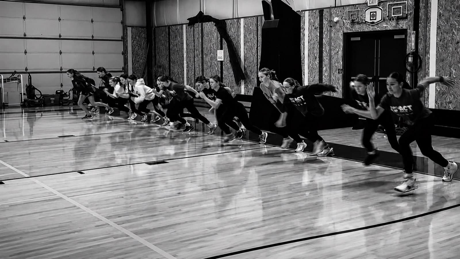 Athletes practicing sprint starts during a team speed training session